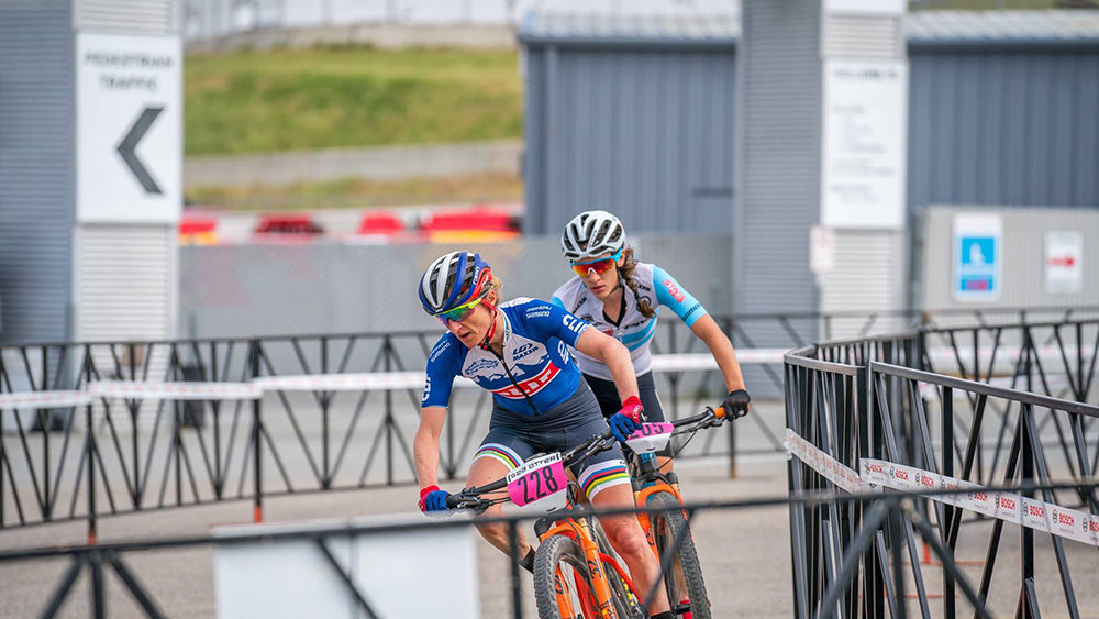 Catharine leading Sofia Gomez Villafane through the race barricades.