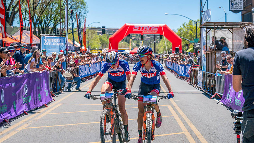 Catherine celebrating a tight finish with her then teammate Haley Batten.