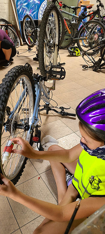 young riders prepare bikes at the Center of Southwest Culture