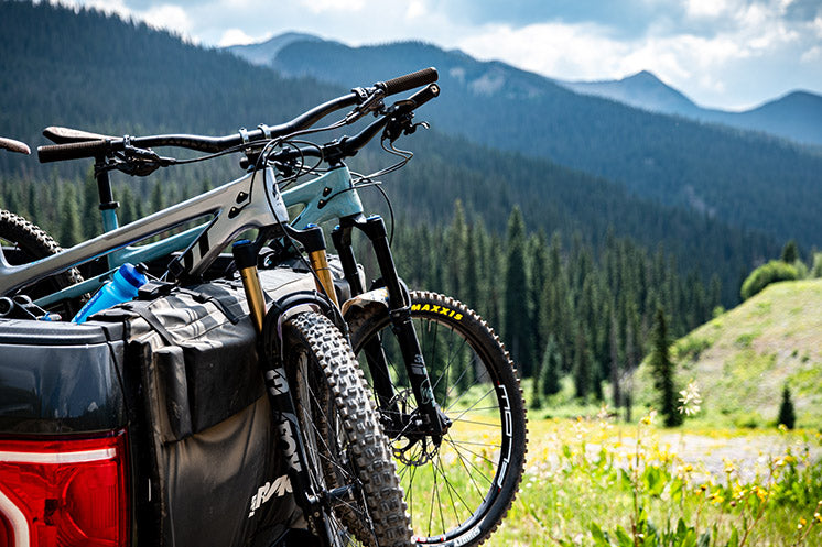 Bikes on truck tailgate pad overlooking scenic vista